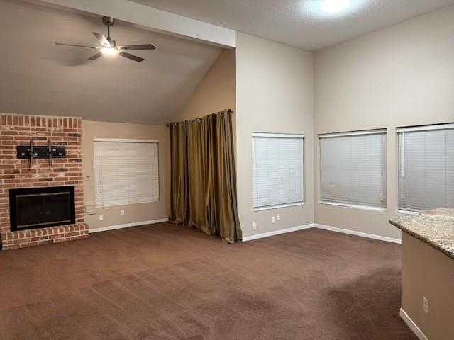 4418 Treasure Trl, Sugar Land, TX 77479 - unfurnished living room with carpet flooring, a ceiling fan, a brick fireplace, beamed ceiling, and high vaulted ceiling