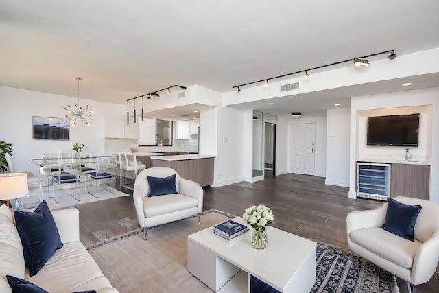 49 Briar Hollow Ln Unit 1106, Houston, TX 77027 - living area with wine cooler, track lighting, wood finished floors, and a chandelier