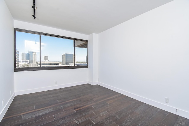49 Briar Hollow Ln Unit 1106, Houston, TX 77027 - spare room featuring dark wood-style flooring, rail lighting, and a city view