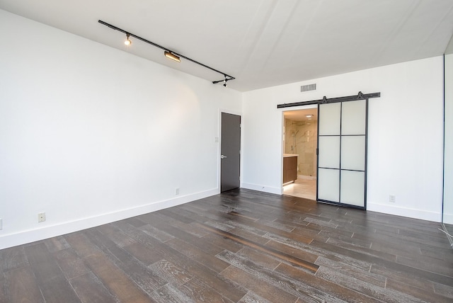 49 Briar Hollow Ln Unit 1106, Houston, TX 77027 - spare room featuring a barn door and dark wood finished floors