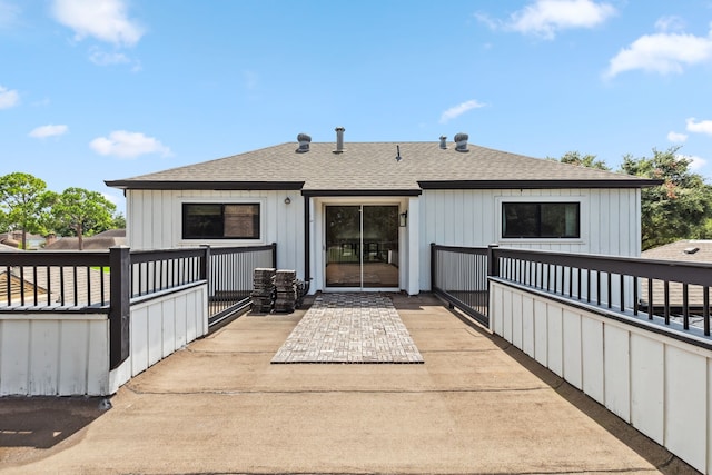 506 Fox Briar Ln, Sugar Land, TX 77478 - back of property with roof with shingles and board and batten siding