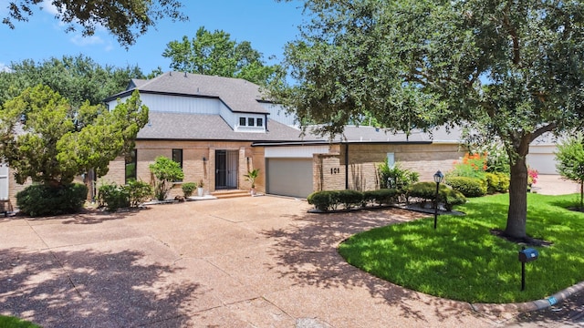 506 Fox Briar Ln, Sugar Land, TX 77478 - view of front of house featuring brick siding, concrete driveway, a front lawn, an attached garage, and roof with shingles