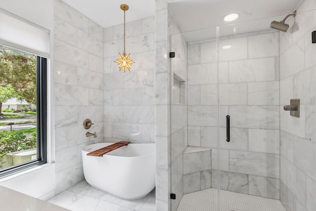 506 Fox Briar Ln, Sugar Land, TX 77478 - bathroom with a freestanding bath, a shower stall, marble finish flooring, and tile walls