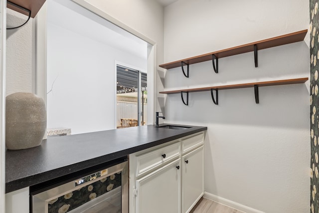 506 Fox Briar Ln, Sugar Land, TX 77478 - indoor dry bar featuring beverage cooler and light wood-type flooring