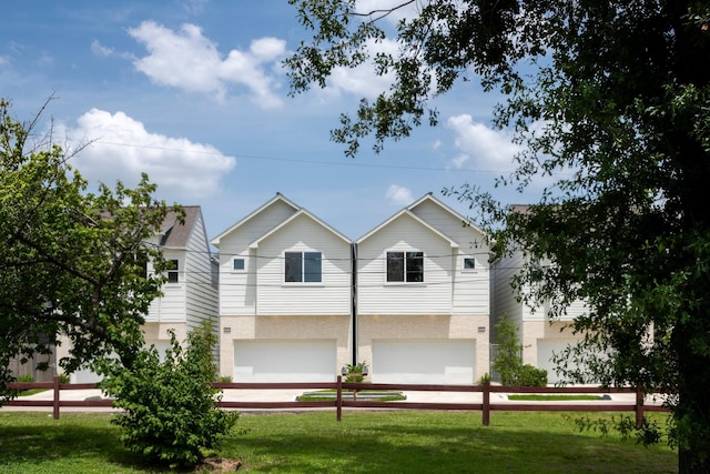 1912 Erastus St, Houston, TX 77020 - view of front facade featuring an attached garage, a front lawn, and stucco siding