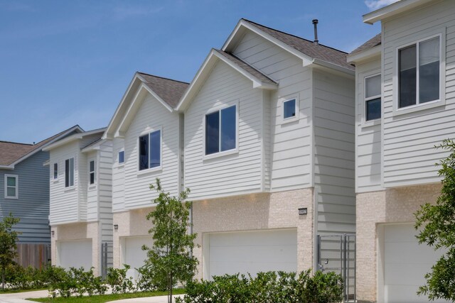 1912 Erastus St, Houston, TX 77020 - view of property exterior with an attached garage and a shingled roof