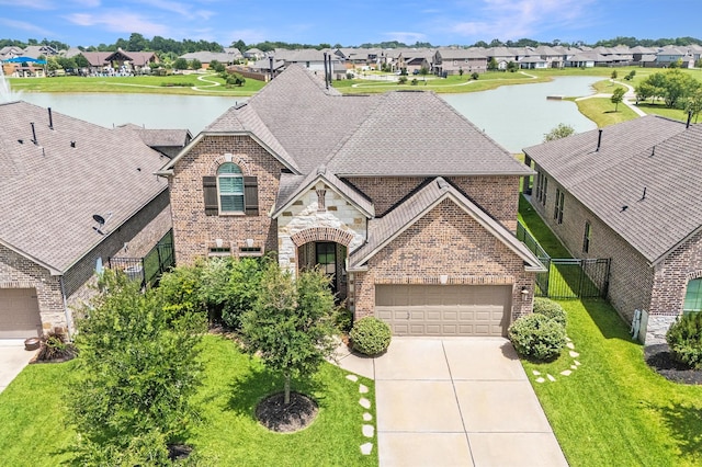 32647 Turning Springs Dr, Fulshear, TX 77423 - view of front of home with brick siding, a water view, and a residential view