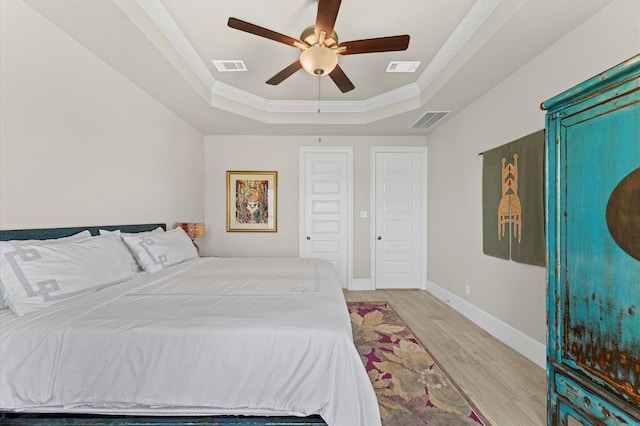 32647 Turning Springs Dr, Fulshear, TX 77423 - bedroom with a tray ceiling, wood finished floors, crown molding, and a ceiling fan