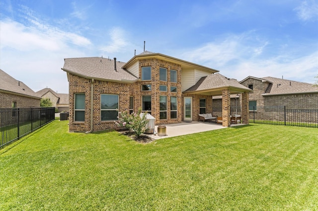 32647 Turning Springs Dr, Fulshear, TX 77423 - rear view of house with a patio, brick siding, a fenced backyard, and a shingled roof