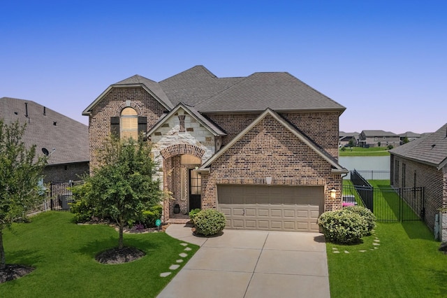 32647 Turning Springs Dr, Fulshear, TX 77423 - french provincial home featuring brick siding, driveway, an attached garage, and a shingled roof
