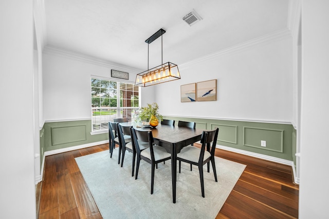 12702 Eagle Ledge Ln, Tomball, TX 77377 - dining space with crown molding, dark wood-type flooring, a wainscoted wall, and a decorative wall