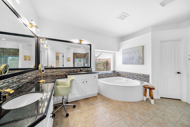 12702 Eagle Ledge Ln, Tomball, TX 77377 - full bathroom featuring a garden tub, double vanity, a shower stall, backsplash, and tile patterned floors