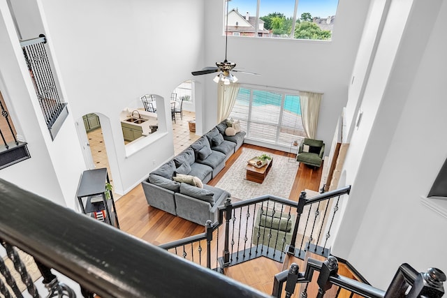 12702 Eagle Ledge Ln, Tomball, TX 77377 - living area featuring a high ceiling, wood finished floors, a ceiling fan, and arched walkways
