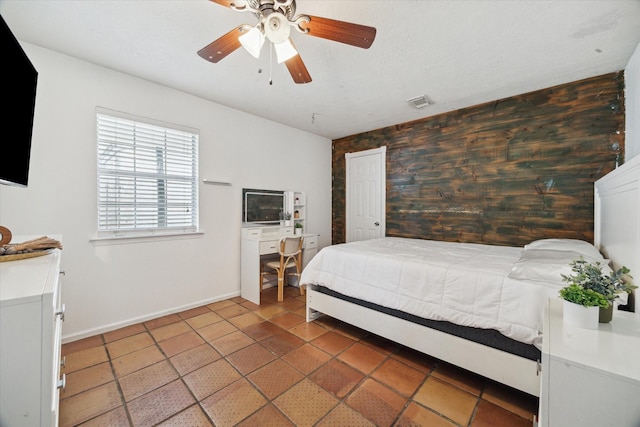 11937 Lakewood W Dr, Cypress, TX 77429 - tiled bedroom featuring ceiling fan and an accent wall