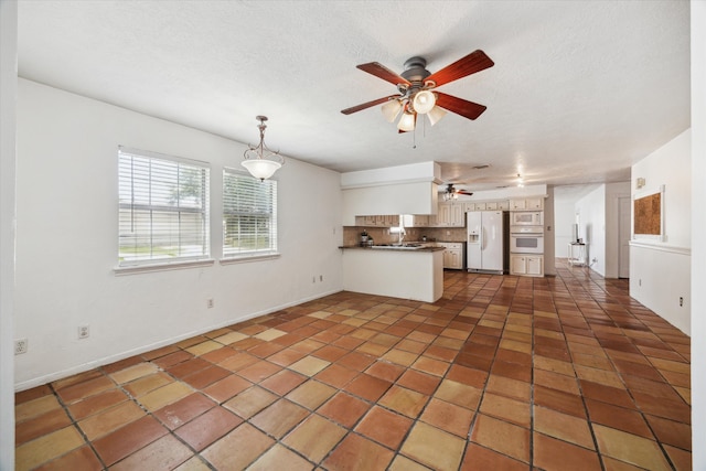 11937 Lakewood W Dr, Cypress, TX 77429 - kitchen featuring white appliances, a peninsula, ceiling fan, dark countertops, and tile patterned flooring