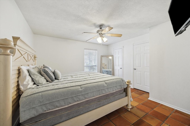 11937 Lakewood W Dr, Cypress, TX 77429 - bedroom with tile patterned flooring, ceiling fan, and a textured ceiling