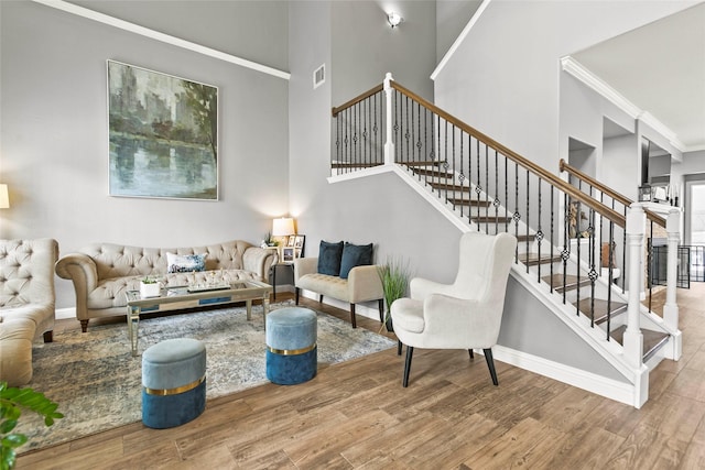 5403 Winlock Trace Ct, Katy, TX 77450 - living area featuring crown molding, wood finished floors, stairs, and a towering ceiling