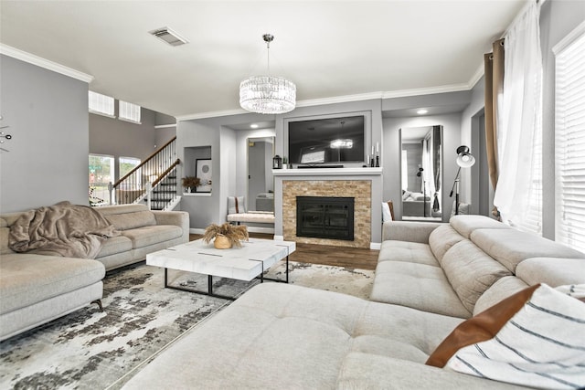 5403 Winlock Trace Ct, Katy, TX 77450 - living room with stairway, a chandelier, ornamental molding, wood finished floors, and a glass covered fireplace