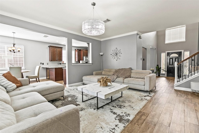 5403 Winlock Trace Ct, Katy, TX 77450 - living area featuring a chandelier, stairway, light wood finished floors, and crown molding