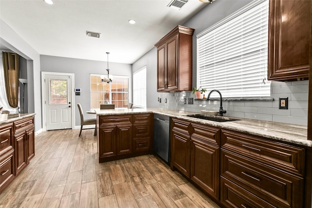 5403 Winlock Trace Ct, Katy, TX 77450 - kitchen featuring stainless steel dishwasher, light wood-style floors, plenty of natural light, backsplash, and recessed lighting