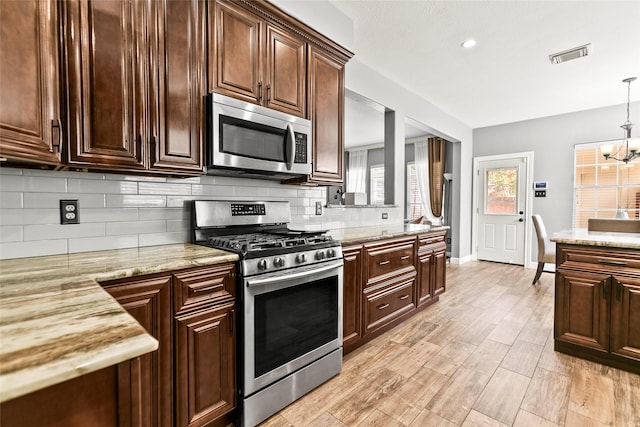 5403 Winlock Trace Ct, Katy, TX 77450 - kitchen featuring appliances with stainless steel finishes, backsplash, a chandelier, dark brown cabinetry, and recessed lighting
