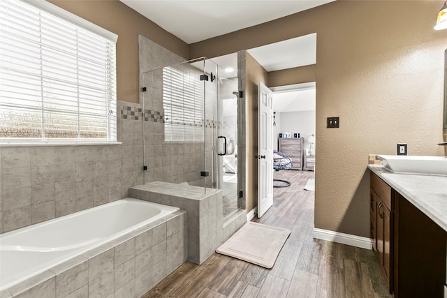 5403 Winlock Trace Ct, Katy, TX 77450 - full bath with a bath, vanity, a shower stall, wood finished floors, and a textured wall
