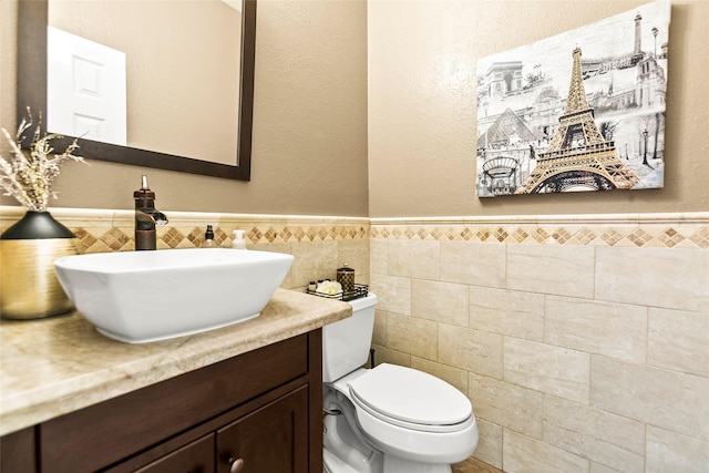 5403 Winlock Trace Ct, Katy, TX 77450 - bathroom with vanity, tile walls, a textured wall, and a wainscoted wall