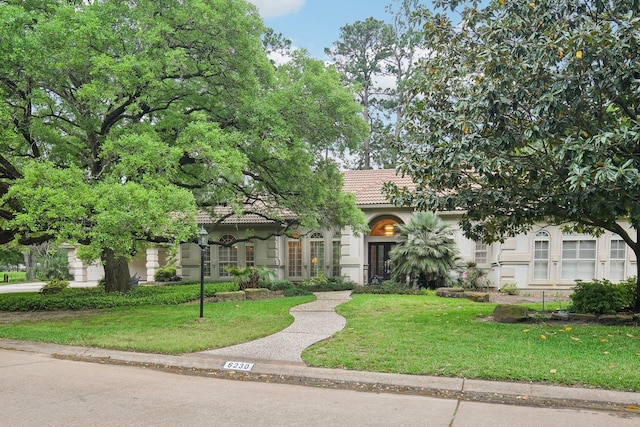 6230 Pebble Beach Dr, Houston, TX 77069 - view of front facade with a front yard, a tiled roof, french doors, and stucco siding