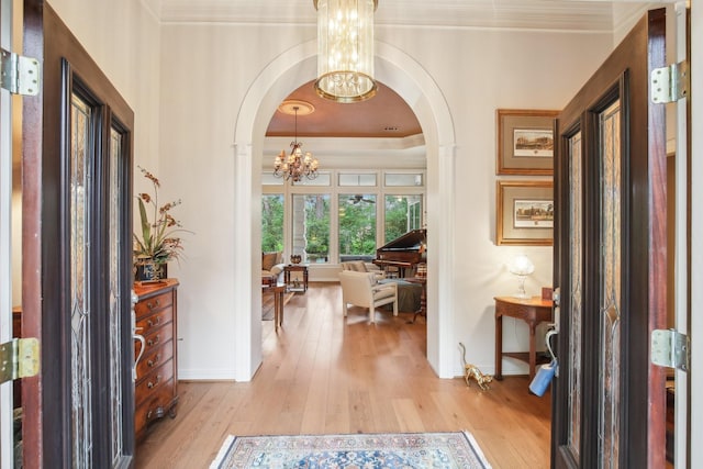 6230 Pebble Beach Dr, Houston, TX 77069 - entrance foyer featuring a chandelier, arched walkways, light wood-type flooring, and crown molding