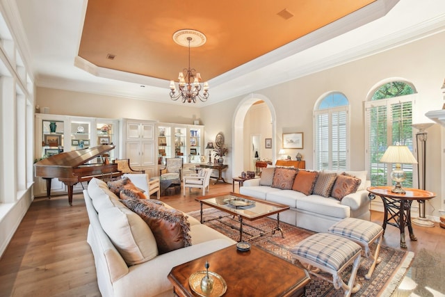 6230 Pebble Beach Dr, Houston, TX 77069 - living area featuring a tray ceiling, hardwood / wood-style flooring, arched walkways, a chandelier, and ornamental molding