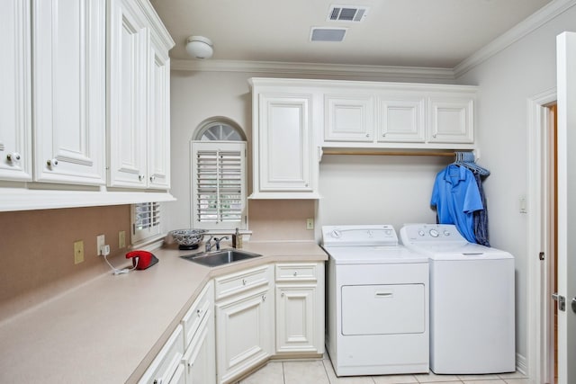 6230 Pebble Beach Dr, Houston, TX 77069 - laundry room featuring separate washer and dryer, cabinet space, ornamental molding, and light tile patterned flooring