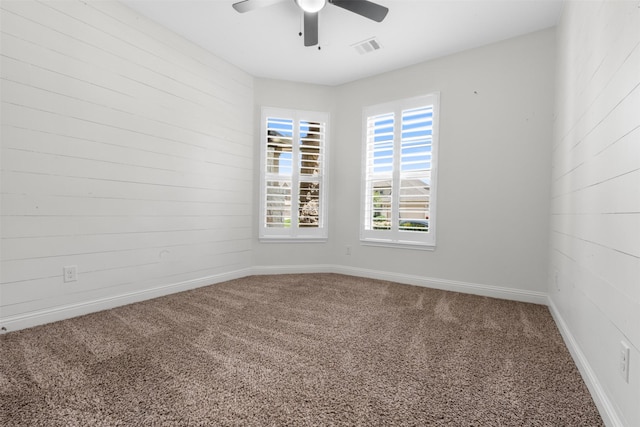 20123 Cascading Falls Blvd, Cypress, TX 77433 - unfurnished room featuring carpet flooring, ceiling fan, and wooden walls
