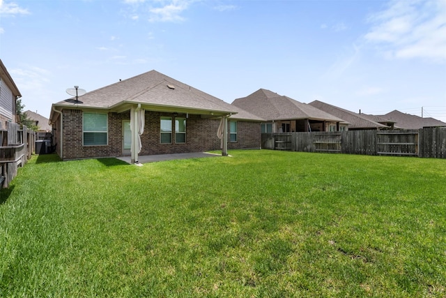 20123 Cascading Falls Blvd, Cypress, TX 77433 - rear view of house with a fenced backyard, a patio, brick siding, and a shingled roof