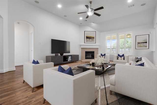 20123 Cascading Falls Blvd, Cypress, TX 77433 - living room with vaulted ceiling, wood finished floors, a tile fireplace, ceiling fan, and arched walkways