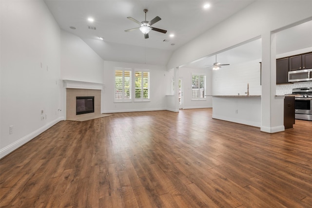 20123 Cascading Falls Blvd, Cypress, TX 77433 - unfurnished living room featuring ceiling fan, lofted ceiling, dark wood finished floors, a tile fireplace, and recessed lighting