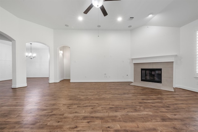 20123 Cascading Falls Blvd, Cypress, TX 77433 - unfurnished living room featuring a ceiling fan, wood finished floors, vaulted ceiling, a fireplace, and arched walkways