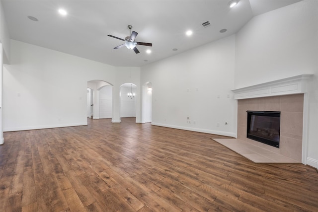 20123 Cascading Falls Blvd, Cypress, TX 77433 - unfurnished living room with arched walkways, ceiling fan, wood finished floors, a tile fireplace, and recessed lighting