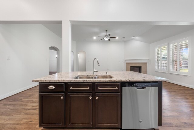 20123 Cascading Falls Blvd, Cypress, TX 77433 - kitchen with stainless steel dishwasher, arched walkways, a ceiling fan, dark brown cabinets, and wood finished floors