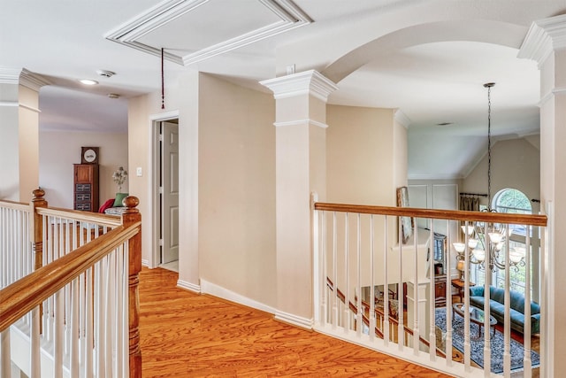 22806 Rachels Manor Dr, Katy, TX 77494 - hallway featuring wood finished floors, an upstairs landing, arched walkways, and ornate columns