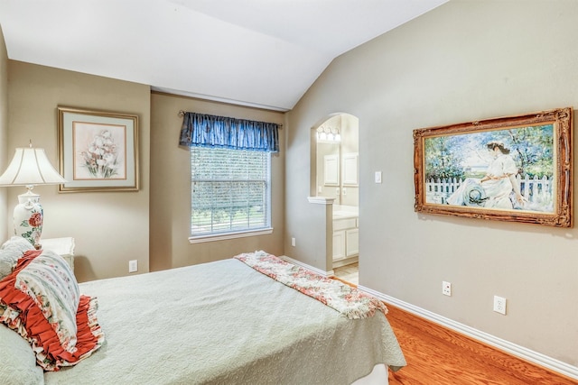 22806 Rachels Manor Dr, Katy, TX 77494 - bedroom with light wood-style floors, arched walkways, connected bathroom, and vaulted ceiling