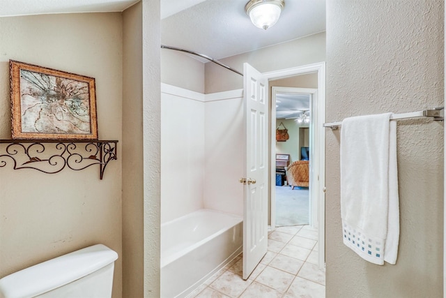 22806 Rachels Manor Dr, Katy, TX 77494 - bathroom featuring tile patterned floors, tub / shower combination, a ceiling fan, and a textured wall