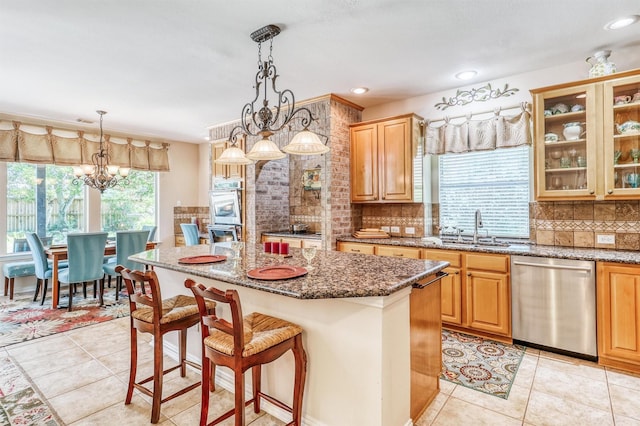 22806 Rachels Manor Dr, Katy, TX 77494 - kitchen with appliances with stainless steel finishes, decorative backsplash, stone counters, a kitchen breakfast bar, and a center island