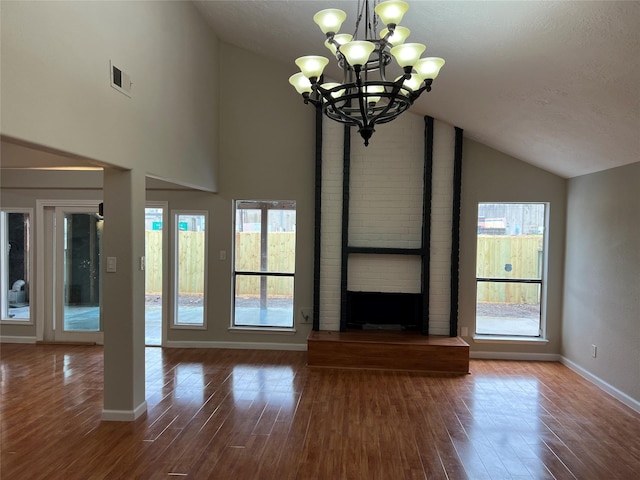 10719 Bellfair Dr, Houston, TX 77072 - unfurnished living room with wood finished floors, high vaulted ceiling, a chandelier, plenty of natural light, and a fireplace