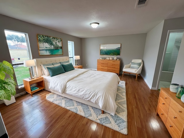 10719 Bellfair Dr, Houston, TX 77072 - bedroom featuring wood finished floors and multiple windows