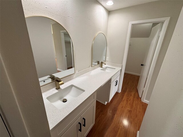 10719 Bellfair Dr, Houston, TX 77072 - bathroom featuring double vanity and wood finished floors