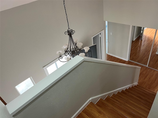 10719 Bellfair Dr, Houston, TX 77072 - stairway featuring a chandelier and wood finished floors