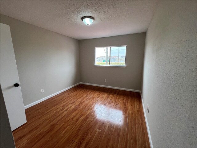 10719 Bellfair Dr, Houston, TX 77072 - spare room with wood finished floors and a textured ceiling