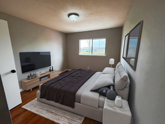 10719 Bellfair Dr, Houston, TX 77072 - bedroom featuring wood finished floors and a textured ceiling