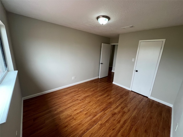 10719 Bellfair Dr, Houston, TX 77072 - unfurnished bedroom with wood finished floors and a textured ceiling