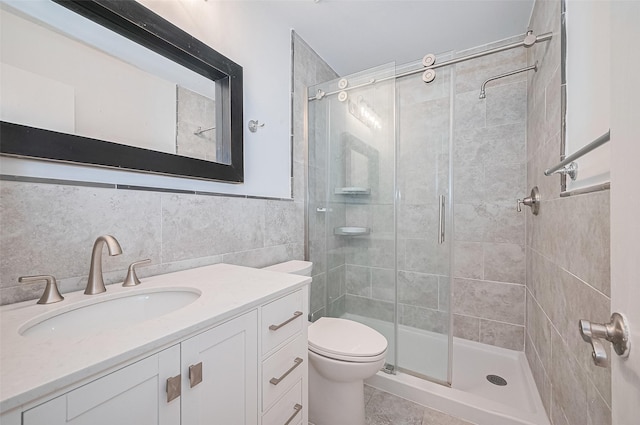 3407 Hillstone Dr, Sugar Land, TX 77479 - bathroom featuring a stall shower, vanity, and tile walls